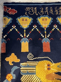 A Sino-Tibetan inscribed woollen 'Dragon' pillar carpet, 19th C.