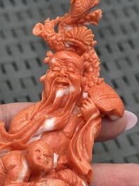 Three Chinese red coral carvings on wooden stands, 19/20th C.