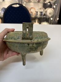 A Chinese green-glazed pottery ritual tripod food vessel with handles, 'Ding 鼎', Han