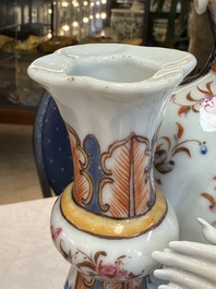 A Chinese famille rose candle holder in the shape of a court lady holding a 'Gu' vase, Qianlong