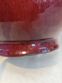 A Chinese flamb&eacute;-glazed vase and a jar with wooden cover, 19th C.