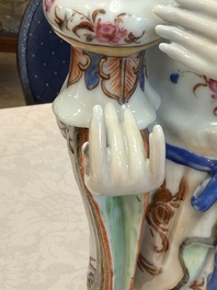 A Chinese famille rose candle holder in the shape of a court lady holding a 'Gu' vase, Qianlong