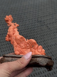 Three Chinese red coral carvings on wooden stands, 19/20th C.
