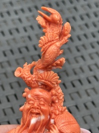 Three Chinese red coral carvings on wooden stands, 19/20th C.