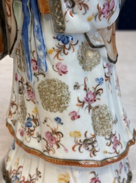 A Chinese famille rose candle holder in the shape of a court lady holding a 'Gu' vase, Qianlong