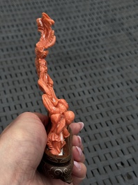 Three Chinese red coral carvings on wooden stands, 19/20th C.