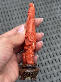 Three Chinese red coral carvings on wooden stands, 19/20th C.