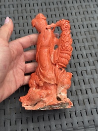 A Chinese carved red coral 'Goddess and Boys' group on a wooden stand, 19/20th C.