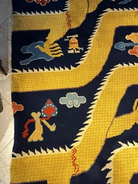A Sino-Tibetan inscribed woollen 'Dragon' pillar carpet, 19th C.