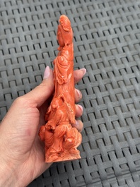 A Chinese carved red coral 'Goddess and Boys' group on a wooden stand, 19/20th C.