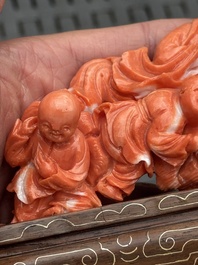 Three Chinese red coral carvings on wooden stands, 19/20th C.