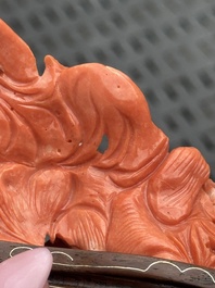 Three Chinese red coral carvings on wooden stands, 19/20th C.