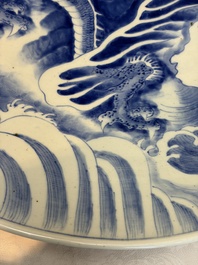 A massive Japanese blue and white 'Dragon among Sea Waves' dish, probably Arita, Meiji, 19th C.