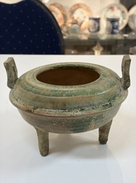 A Chinese green-glazed pottery ritual tripod food vessel with handles, 'Ding 鼎', Han