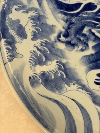 A massive Japanese blue and white 'Dragon among Sea Waves' dish, probably Arita, Meiji, 19th C.