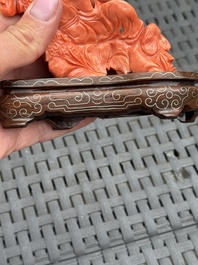 Three Chinese red coral carvings on wooden stands, 19/20th C.