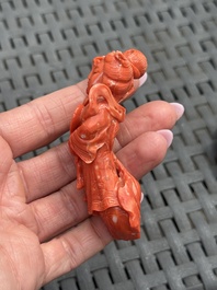 Three Chinese red coral carvings on wooden stands, 19/20th C.