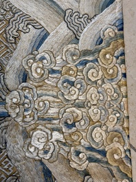 A Chinese cream-ground embroidered silk panel with bats, floral scrolls, waves and rockwork, 19th C.