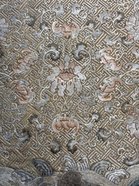 A Chinese cream-ground embroidered silk panel with bats, floral scrolls, waves and rockwork, 19th C.