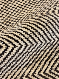 A very large Persian hand-knotted woollen carpet with a geometric patchwork design, 20th C.