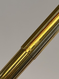 A gold-plated twist ballpoint pen and a fountain pen with an 18kt gold nib, S.T. Dupont Paris, France, 20th C.
