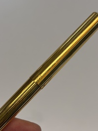 A gold-plated twist ballpoint pen and a fountain pen with an 18kt gold nib, S.T. Dupont Paris, France, 20th C.