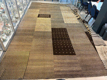 A very large Persian hand-knotted woollen carpet with a geometric patchwork design, 20th C.