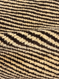A very large Persian hand-knotted woollen carpet with a geometric patchwork design, 20th C.