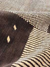 A large Persian hand-knotted woollen carpet with a geometric patchwork design, 20th C.