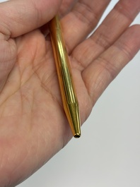A gold-plated twist ballpoint pen and a fountain pen with an 18kt gold nib, S.T. Dupont Paris, France, 20th C.