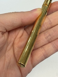 A gold-plated twist ballpoint pen and a fountain pen with an 18kt gold nib, S.T. Dupont Paris, France, 20th C.