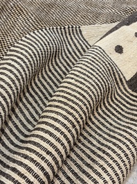A large Persian hand-knotted woollen carpet with a geometric patchwork design, 20th C.