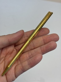 A gold-plated twist ballpoint pen and a fountain pen with an 18kt gold nib, S.T. Dupont Paris, France, 20th C.