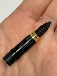 A gold-plated twist ballpoint pen and a fountain pen with an 18kt gold nib, S.T. Dupont Paris, France, 20th C.