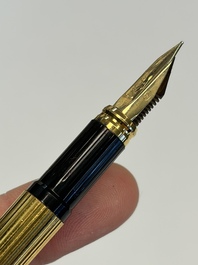A gold-plated twist ballpoint pen and a fountain pen with an 18kt gold nib, S.T. Dupont Paris, France, 20th C.