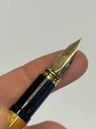 A gold-plated twist ballpoint pen and a fountain pen with an 18kt gold nib, S.T. Dupont Paris, France, 20th C.
