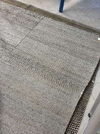 A very large Persian hand-knotted woollen carpet with a geometric patchwork design, 20th C.