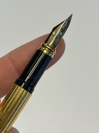 A gold-plated twist ballpoint pen and a fountain pen with an 18kt gold nib, S.T. Dupont Paris, France, 20th C.