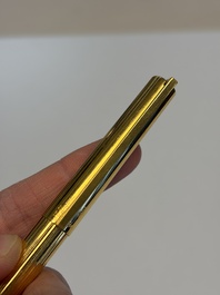 A gold-plated twist ballpoint pen and a fountain pen with an 18kt gold nib, S.T. Dupont Paris, France, 20th C.