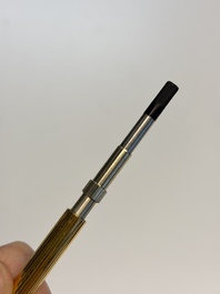 A gold-plated twist ballpoint pen and a fountain pen with an 18kt gold nib, S.T. Dupont Paris, France, 20th C.