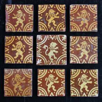 A lot of 9 slipware decorated post-medieval tiles with rampant lions, 17/18th C., Franco-Flemish