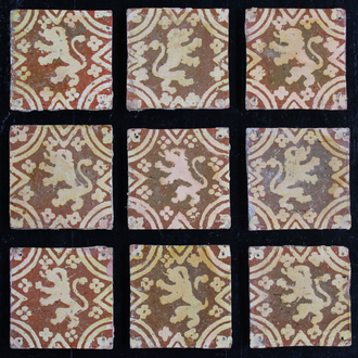 A lot of 9 slipware decorated post-medieval tiles with rampant lions, 17/18th C., Franco-Flemish