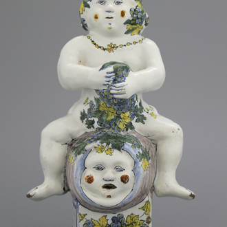 A Brussels faience table fountain, modelled as Bacchus seated on a barrel, 18th C.