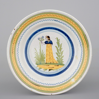 A Brussels faience plate with a lady, 18th C.
