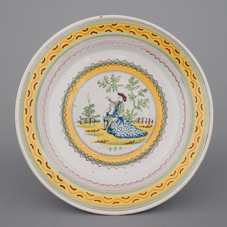 A fine Brussels faience plate with a romantic scene, 18th C.