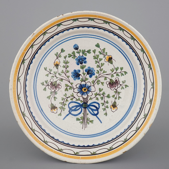 A Brussels faience plate with a bouquet of flowers, 18th C.