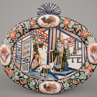 A Dutch Delft black-enhanced oval plaque with chinoiserie, ca. 1800