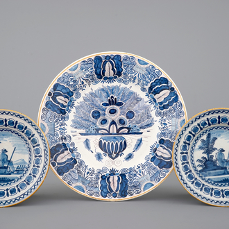 A pair of blue and white Dutch Delft pastoral plates and a peacock's tail dish, 18/19th C.