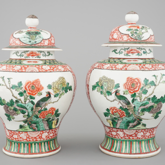 A pair of Chinese famille verte porcelain baluster vases and covers, 19th C.
