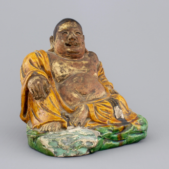 A Chinese sancai-glazed pottery Buddha, late Ming Dynasty